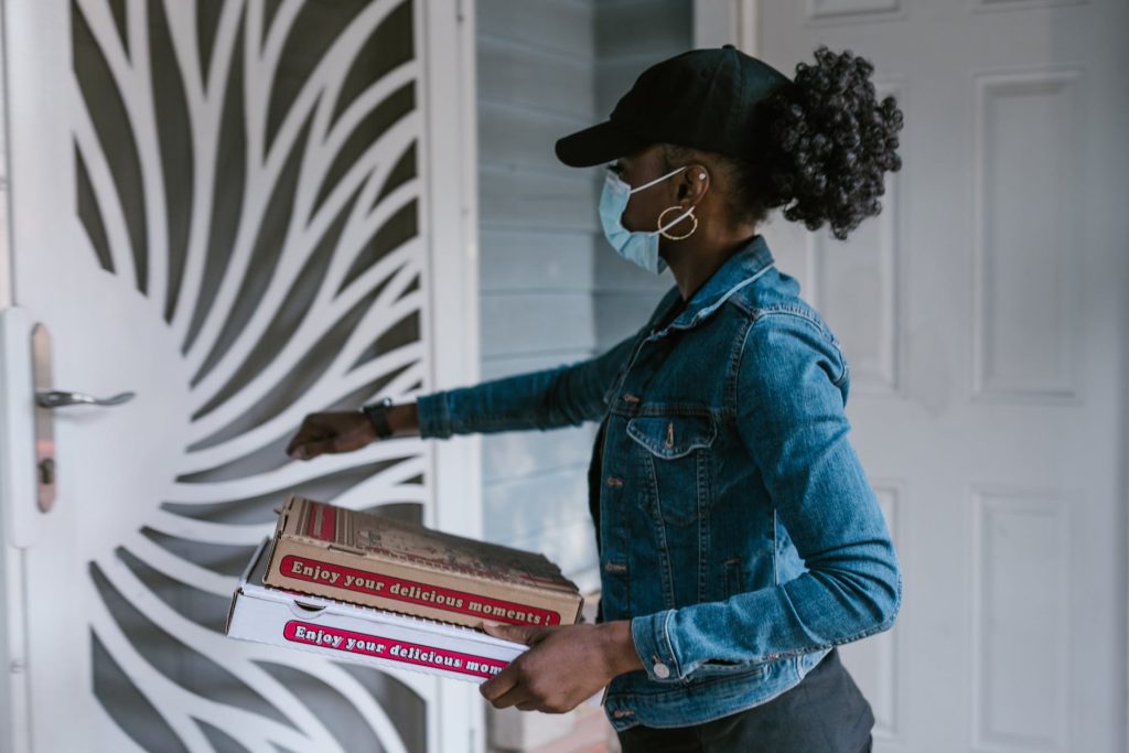 pizza delivery driver delivering pizza to a door
