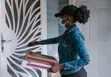 pizza delivery driver delivering pizza to a door