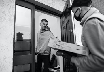 pizza delivery driver delivers pizza to customer