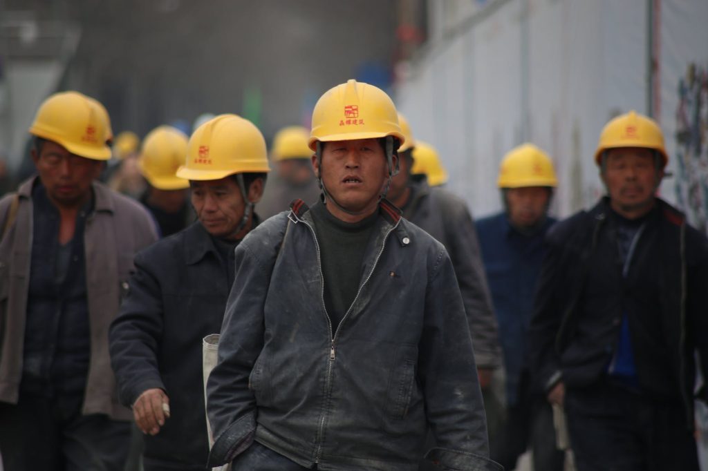 group of workers wearing yellow hardhats