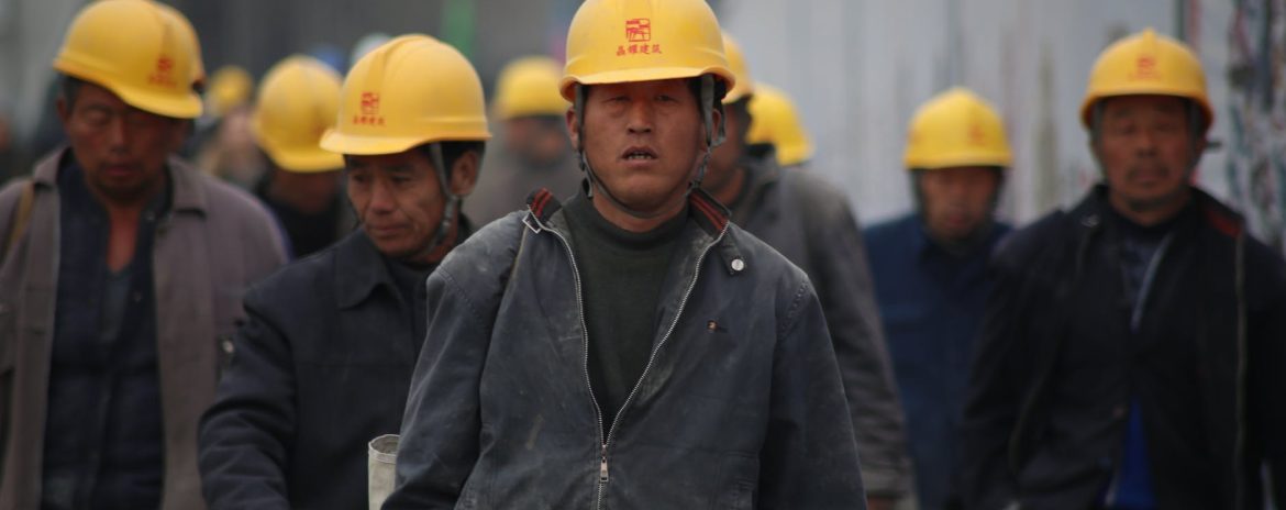 group of workers wearing yellow hardhats