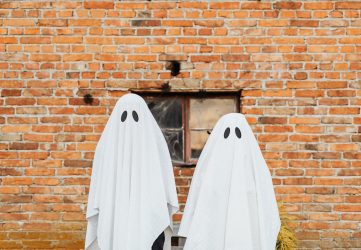 two ghosts standing at their job