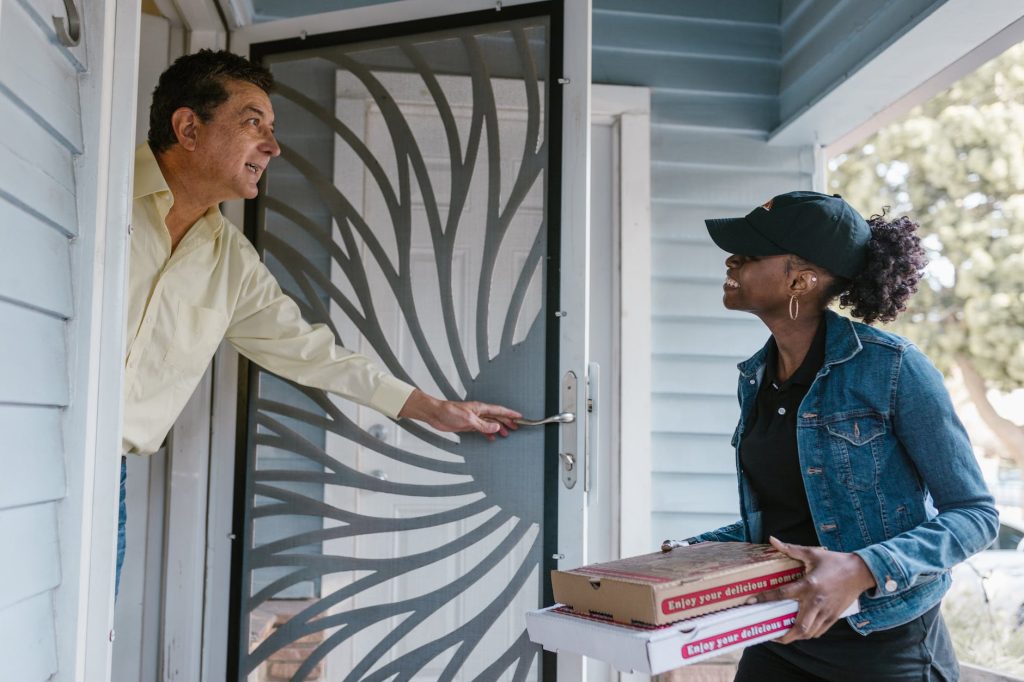 delivery driver delivering pizza to customer
